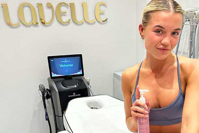 Molly in treatment room with harmony xl pro is behind her